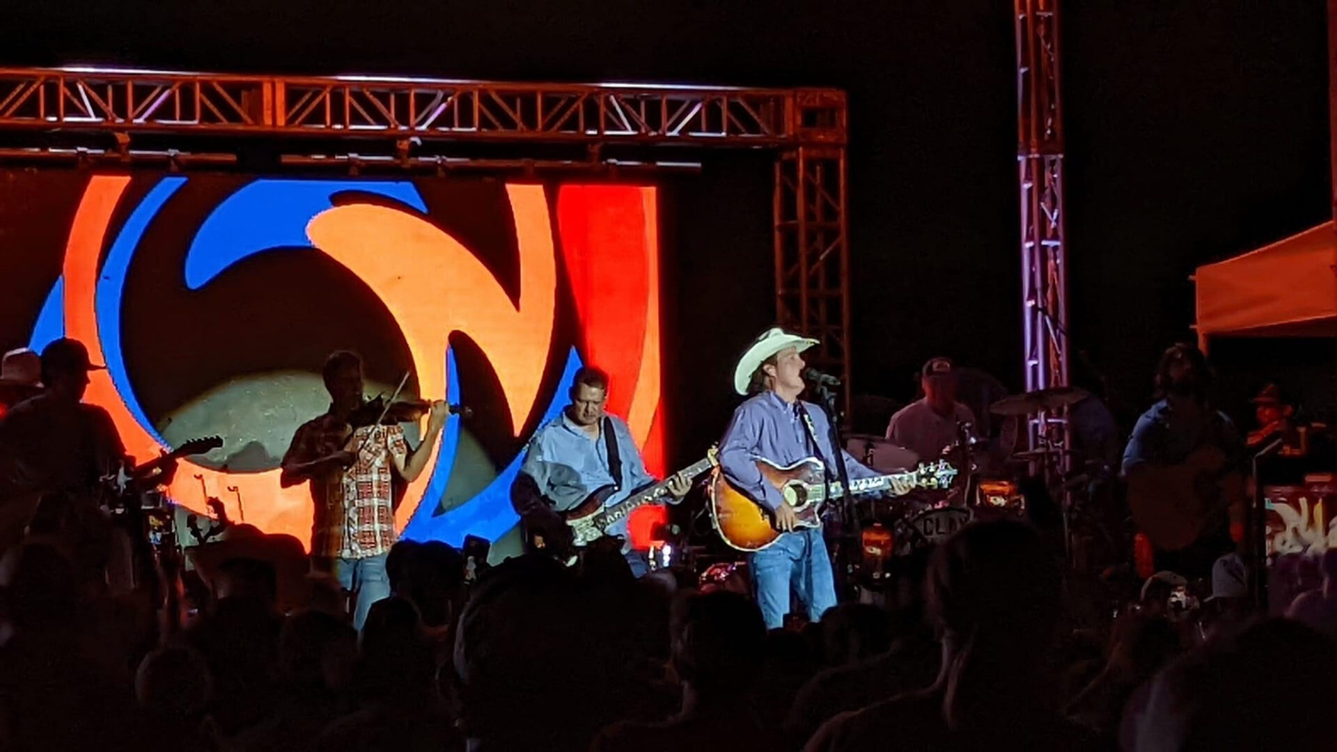 A band playing the CRMF stage at night with a giant video wall