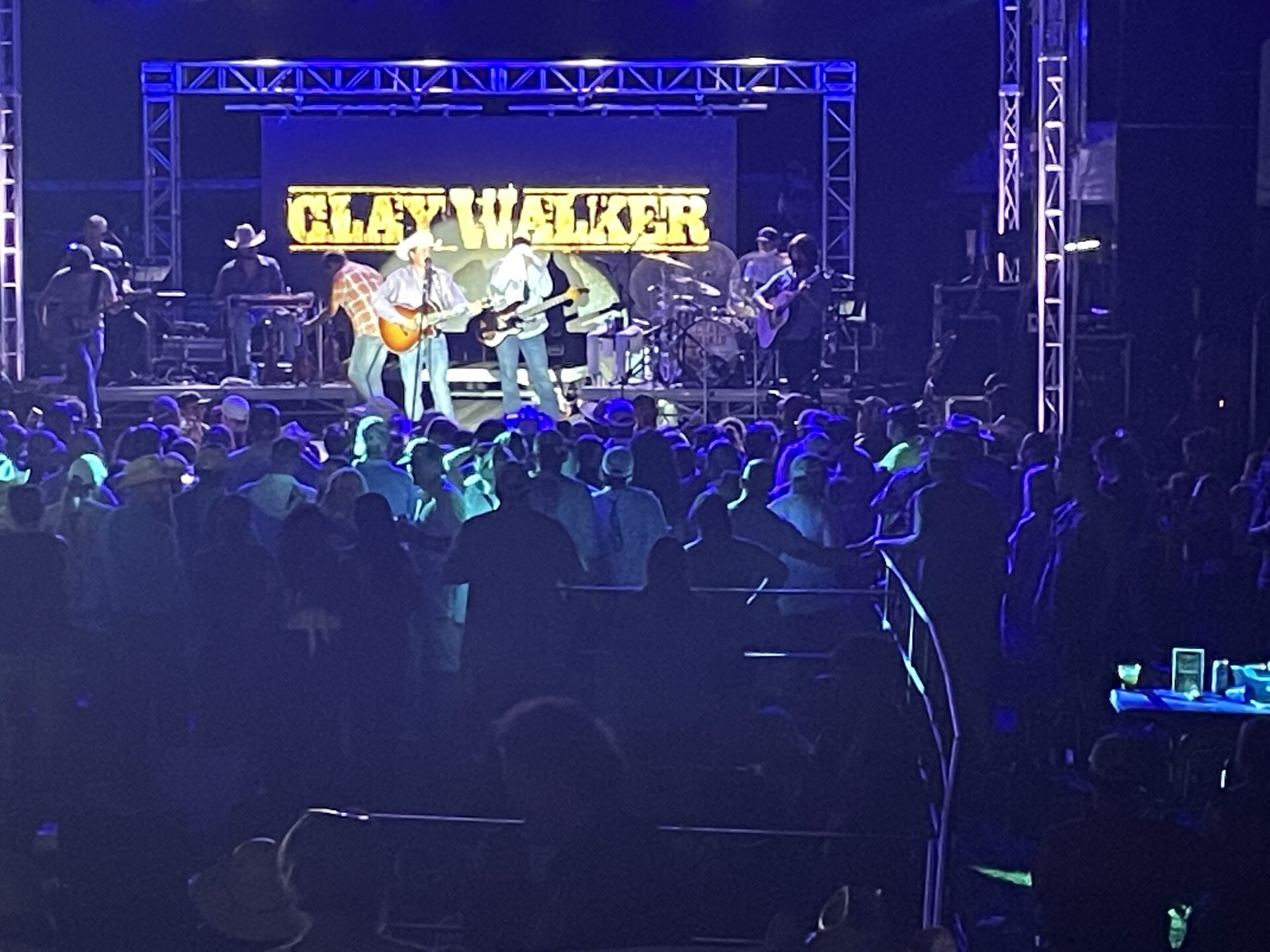 Blue stage lights over a big crowd during a headline set